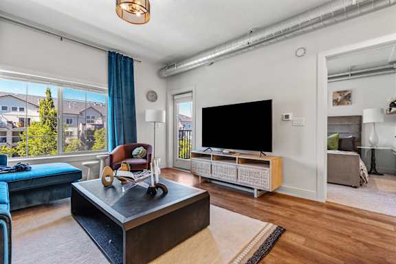 A living room with a black sofa and a black TV.