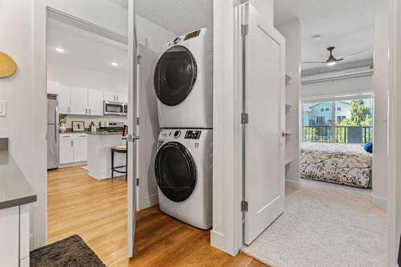 A white door is open to a room with a washer and dryer in it. at The Revival, Utah