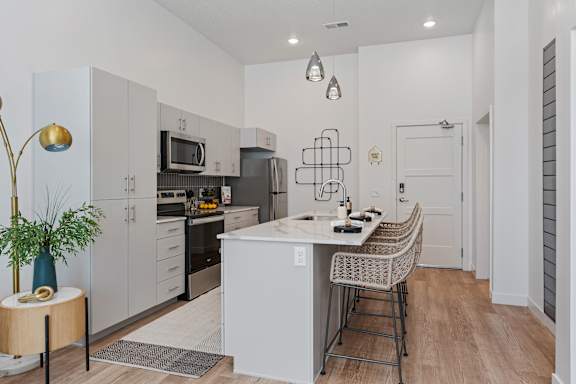 A modern kitchen with a dining table and chairs.