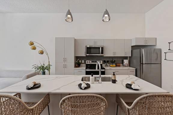 A modern kitchen with a dining table and chairs.