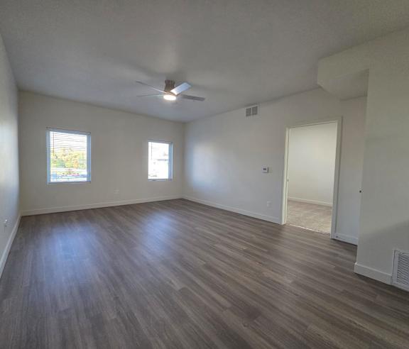 Empty room with wooden flooring and a ceiling fan at The View on 20th, Ogden