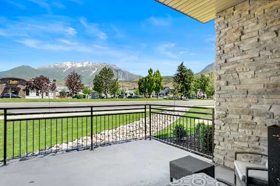 Balcony with a stone pillar at The Flats at Riverwoods, Provo, UT