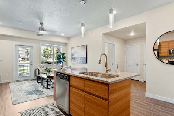 Kitchen with wooden island at The Flats at Riverwoods, Provo