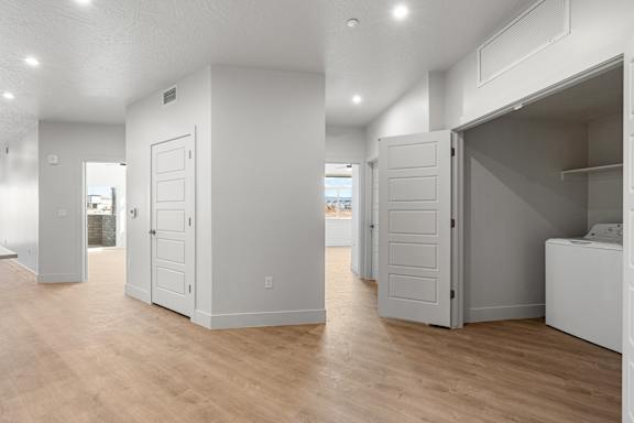A white room with wooden floors and white walls. at The Vue At Desert Color, St. George, UT, 84790