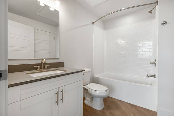 A white bathroom with a toilet, sink, and bathtub. at The Vue At Desert Color, St. George, 84790