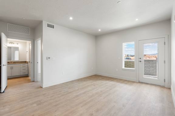 A spacious room with a view of the beach through the window. at The Vue At Desert Color, St. George, Utah