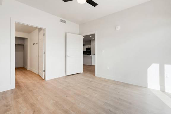 A room with a ceiling fan and wooden flooring. at The Vue At Desert Color, Utah, 84790
