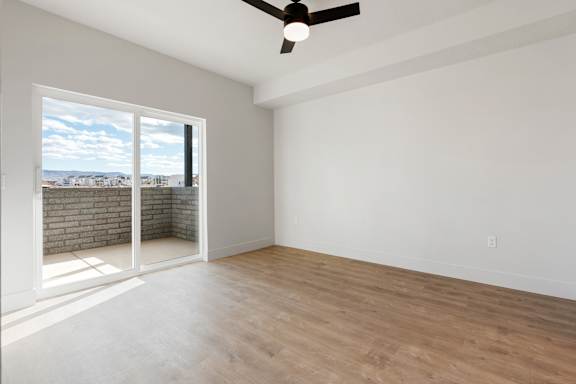 Empty room with a ceiling fan and a view of the outside through a window. at The Vue At Desert Color, St. George, 84790
