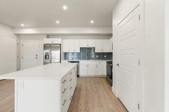 A kitchen with white cabinets and a white counter top. at The Vue At Desert Color, St. George, 84790