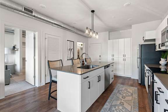 A modern kitchen with a large island and a sink.