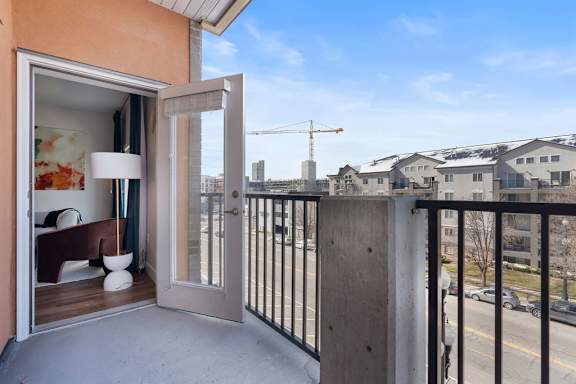 Private balcony with metal railing and city views at The Revival Apartments, Salt Lake City, UT