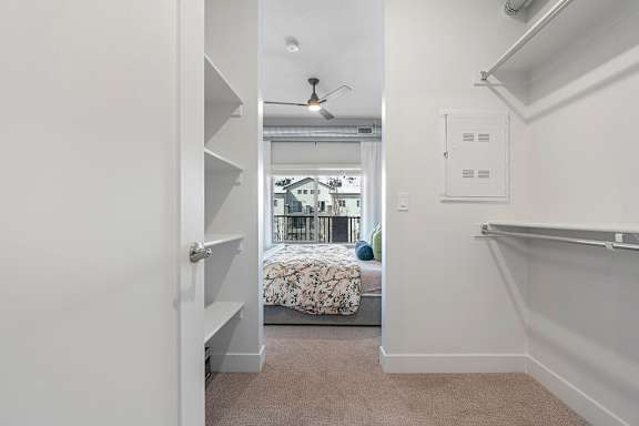 A bedroom with a bed and a window.