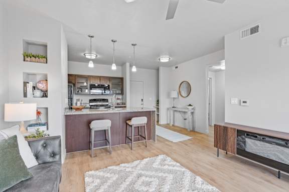 A modern kitchen with a bar area and a dining table. at Wilmington Flats Apartments, Salt Lake City, 84106
