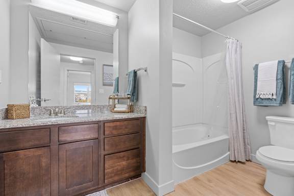 A bathroom with a white toilet, a white sink, and a white bathtub. at Wilmington Flats Apartments, Salt Lake City, Utah