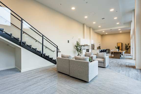 A living room with a staircase and a couch.