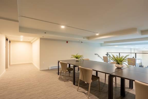 A conference room with a long table and chairs.