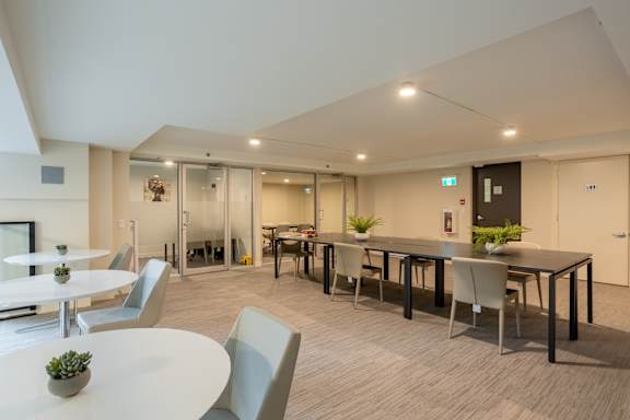 A modern dining area with a long table and chairs.