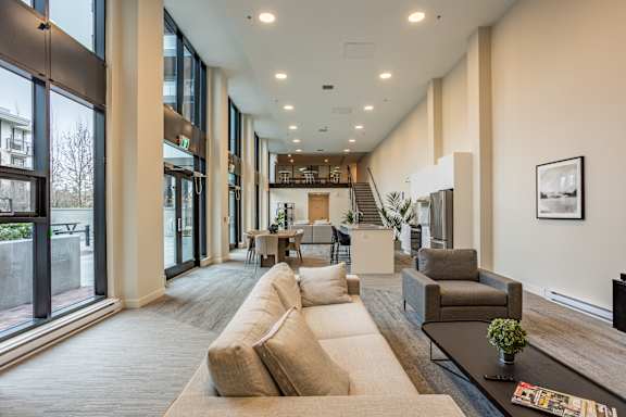A spacious living room with a long couch and a coffee table.