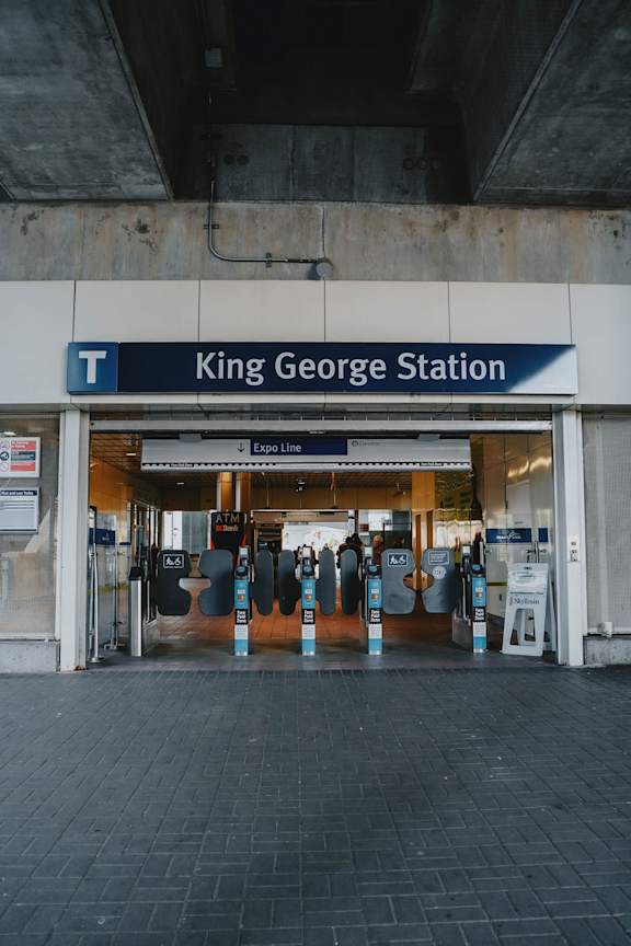 A subway station entrance with a sign that says King George Station.