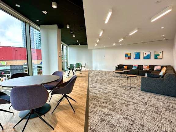A room with a table and chairs and a couch.