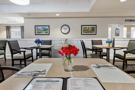 A dining area with tables set for a meal.