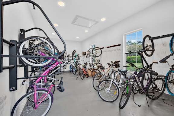 A bike rack full of bicycles in a room.
