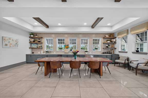 A dining room with a table and chairs.