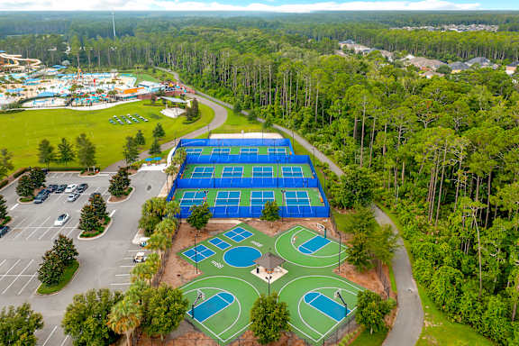 A large blue tarp covers a tennis court.