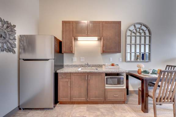 A kitchen with wooden cabinets and a granite countertop.