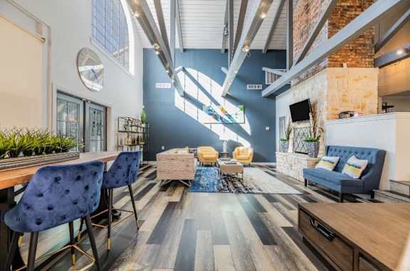A modern living room with a blue chair and a white couch.