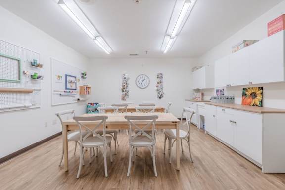 Community craft room with workspace and storage at Schuyler Commons Apartments, Utica, New York