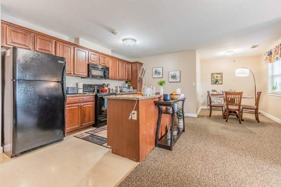 Open concept kitchen and dining area at Schuyler Commons Apartments, Utica, NY 13502