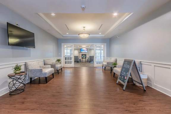 Community waiting room with coffered ceiling at Glenmont Abbey Village, 55+ Apartments, Glenmont, 12077