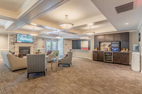 Clubhouse lounge with coffee station and seating at Glenmont Abbey Village, 55+ Apartments, Glenmont