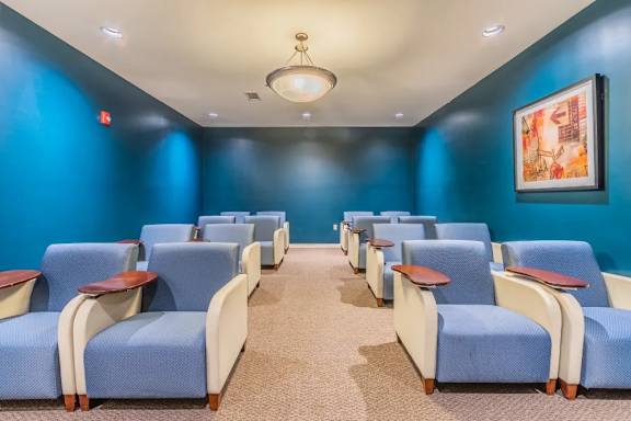 Theater room with recliners and blue lighting at Glenmont Abbey Village, 55+ Apartments, New Jersey, 12077