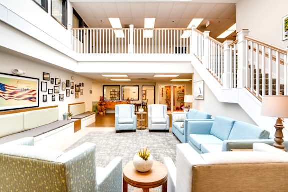 A living room with a staircase and a couch. at King City Senior Village Apartments, King City, 97224