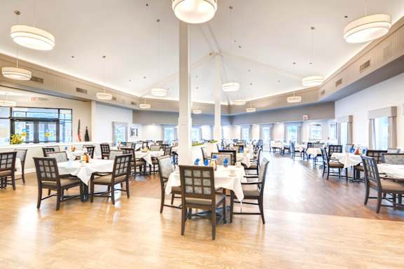 A restaurant with tables and chairs set up for dining. at King City Senior Village Apartments, Oregon