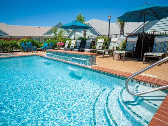 A swimming pool with a 3 ft deep sign. at Sunstone Village Apartments, Denton, 76208