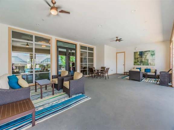 A patio with furniture and a ceiling fan. at Sunstone Village Apartments, Denton, TX