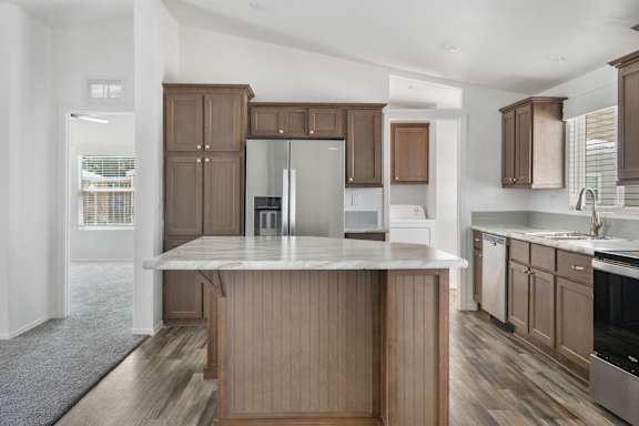 A kitchen with wooden cabinets and a marble countertop.