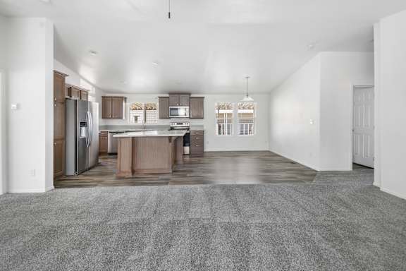 A spacious kitchen with a dining area and a large island.