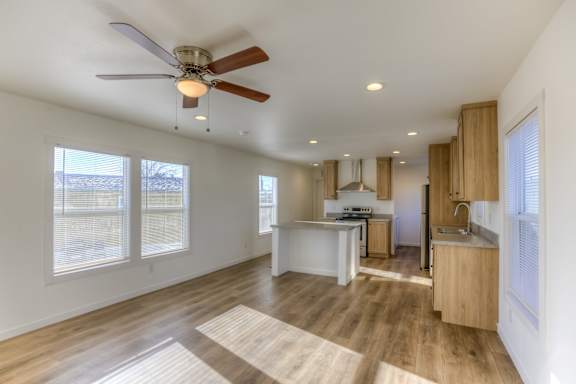 A modern kitchen with a fan on the ceiling.