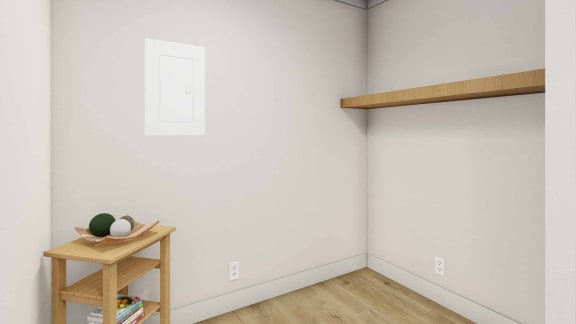 a corner of a room with a small shelf and a painting on the wall