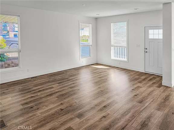A room with wooden flooring and white walls.