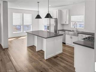 A modern kitchen with white cabinets and a central island.