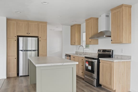 a kitchen with wooden cabinets and stainless steel appliances