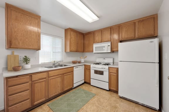 refrigerator, microwave, dishwasher and gas range in a Tyner Ranch kitchen