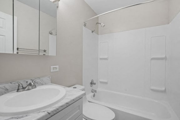 bathtub toilet and sink in a bathroom at The Meridian at Lakewood, Lakewood, 80228