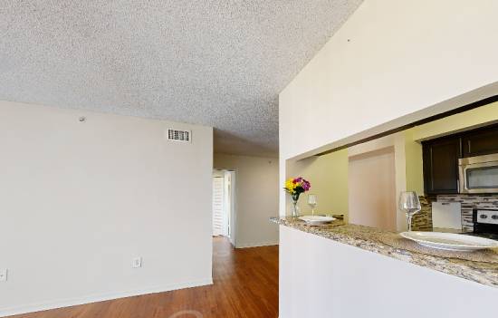 A kitchen area with a counter and a microwave.