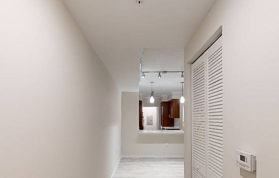 A white door with a sign that says "Presented by Atlantic Pacific" is in a room with white walls.